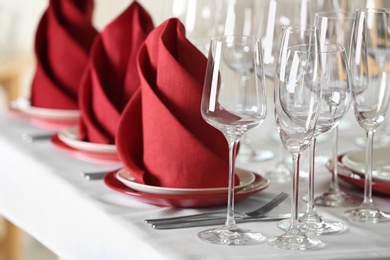 Photo of Table setting with empty glasses, plates and cutlery on table