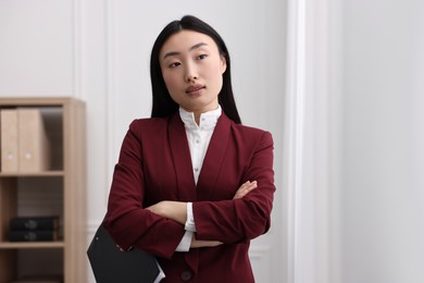 Portrait of notary with crossed arms in office