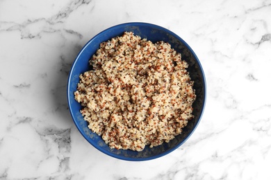 Cooked delicious quinoa in bowl on table, top view