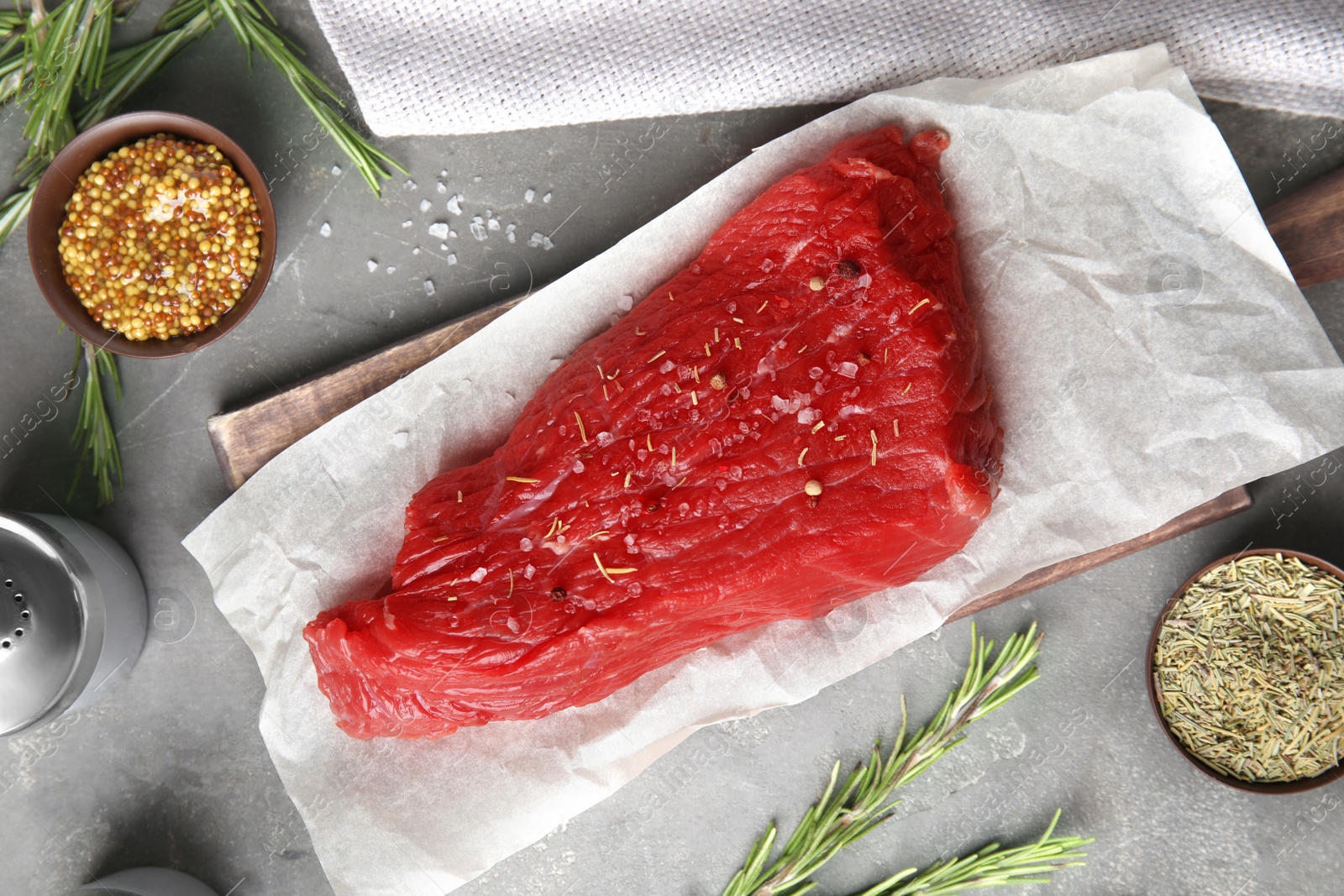 Photo of Flat lay composition with fresh beef cut on grey table