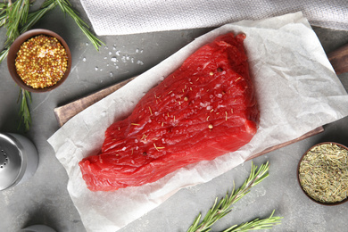 Flat lay composition with fresh beef cut on grey table