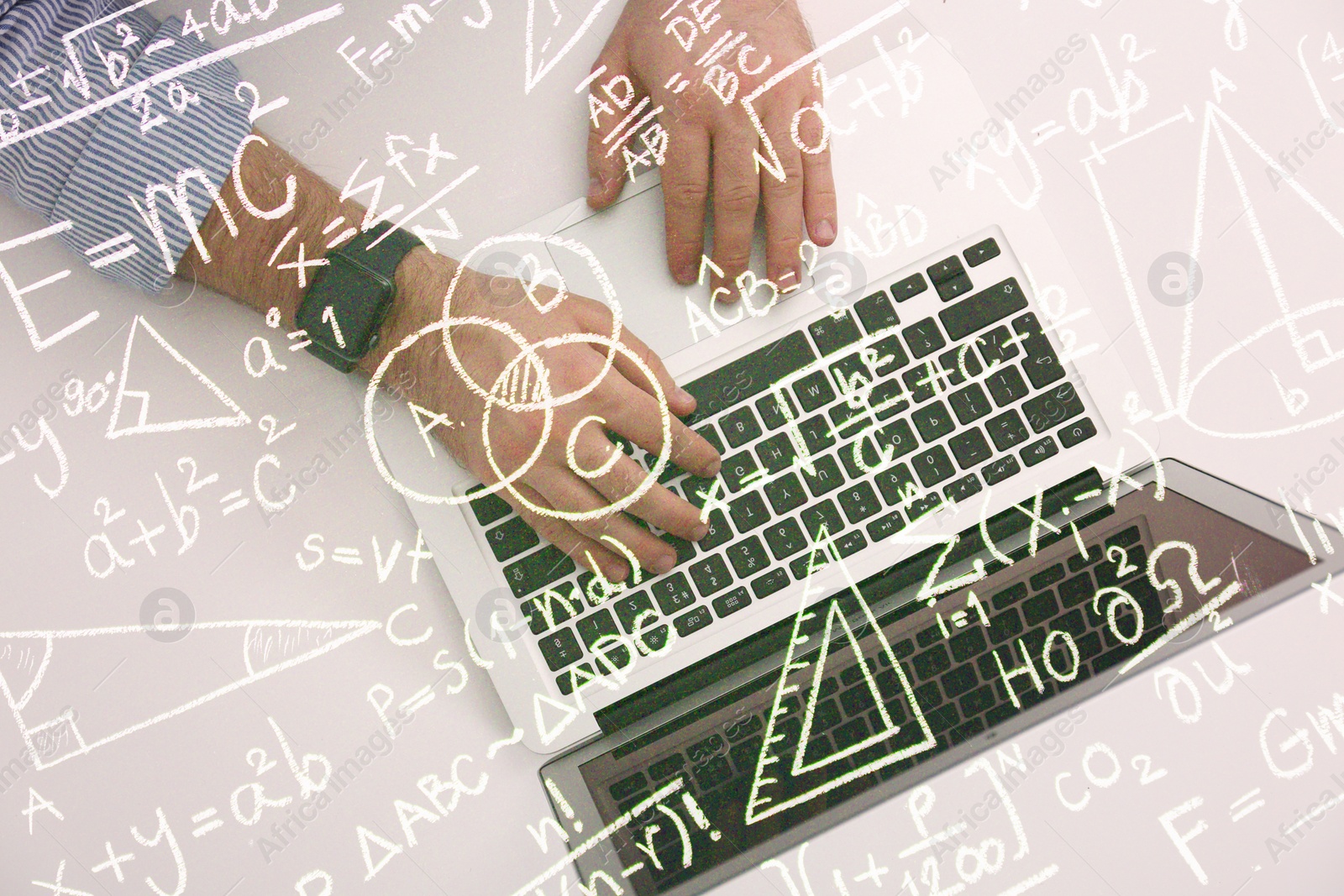 Image of Science and education concept. Illustration of basic physics and mathematics formulas and man working on laptop at table, top view