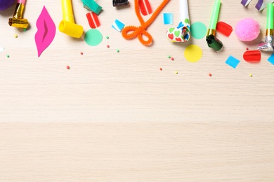 Photo of Flat lay composition with party items on wooden background. Space for text