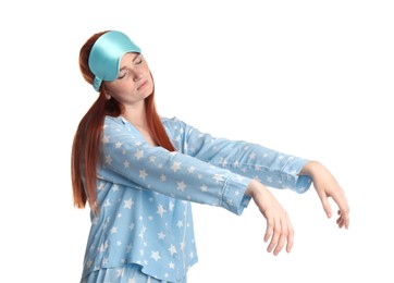 Photo of Young woman wearing pajamas and mask in sleepwalking state on white background