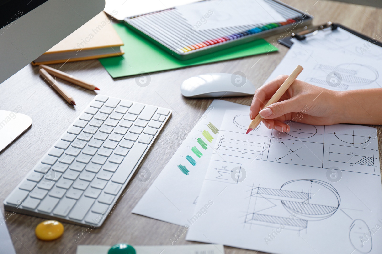 Photo of Female designer working at wooden table, closeup