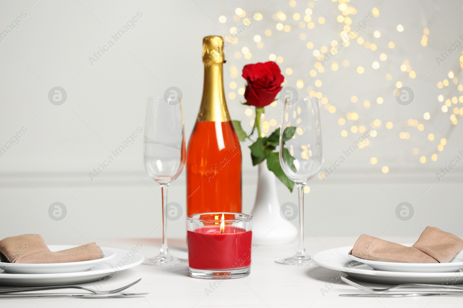 Photo of Beautiful table setting with burning candle and rose for romantic dinner