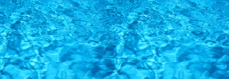 Texture of blue water in swimming pool as background. Banner design