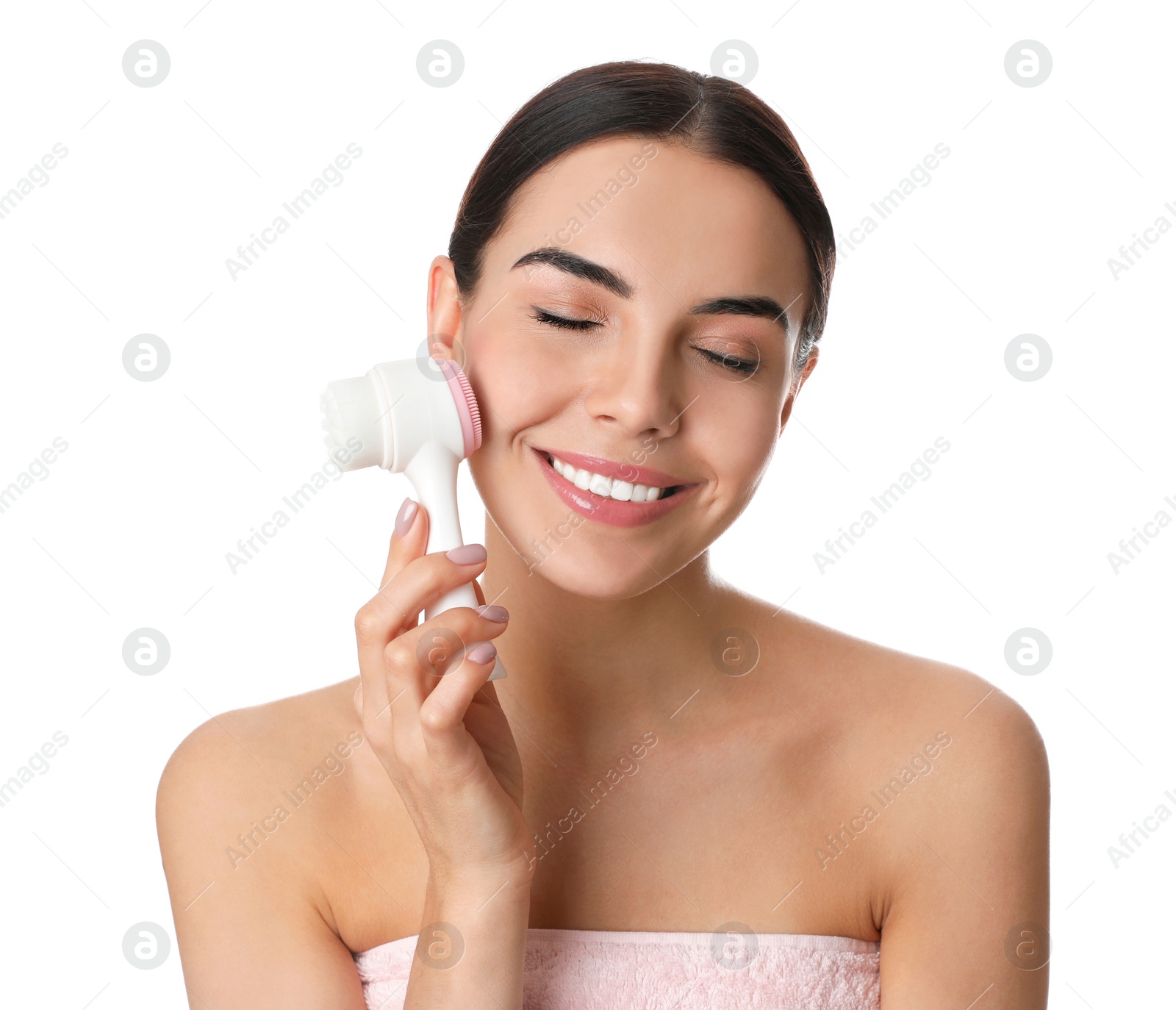 Photo of Young woman using facial cleansing brush on white background. Washing accessory