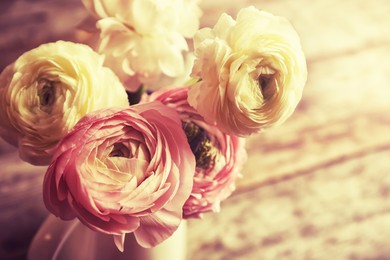 Image of Vase with beautiful ranunculus flowers on table, closeup