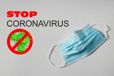 Medical mask and text Stop Coronavirus on light background. Protective measures during pandemic
