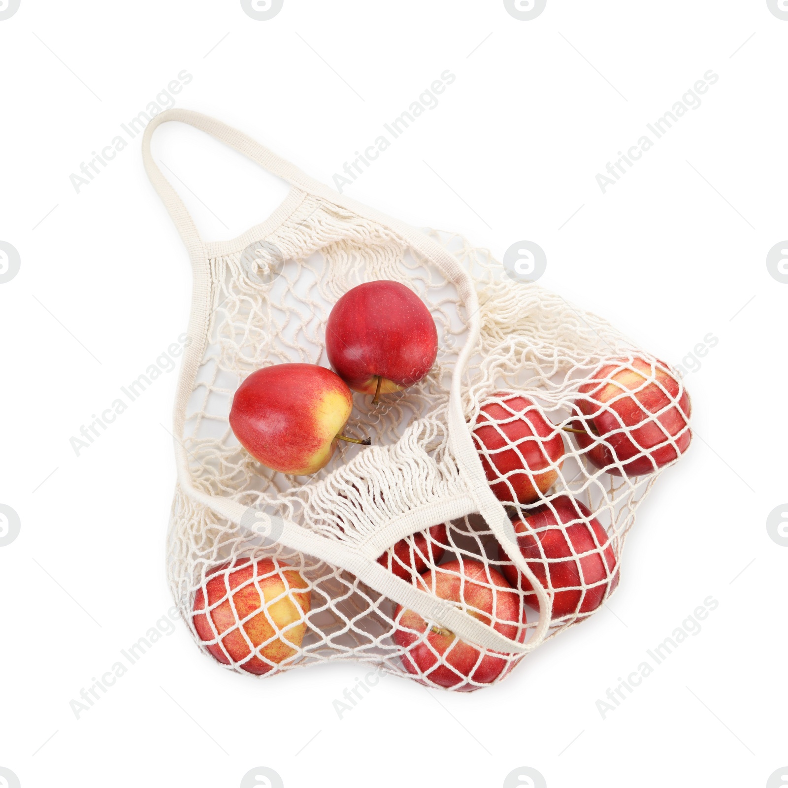 Photo of String bag with apples isolated on white, top view