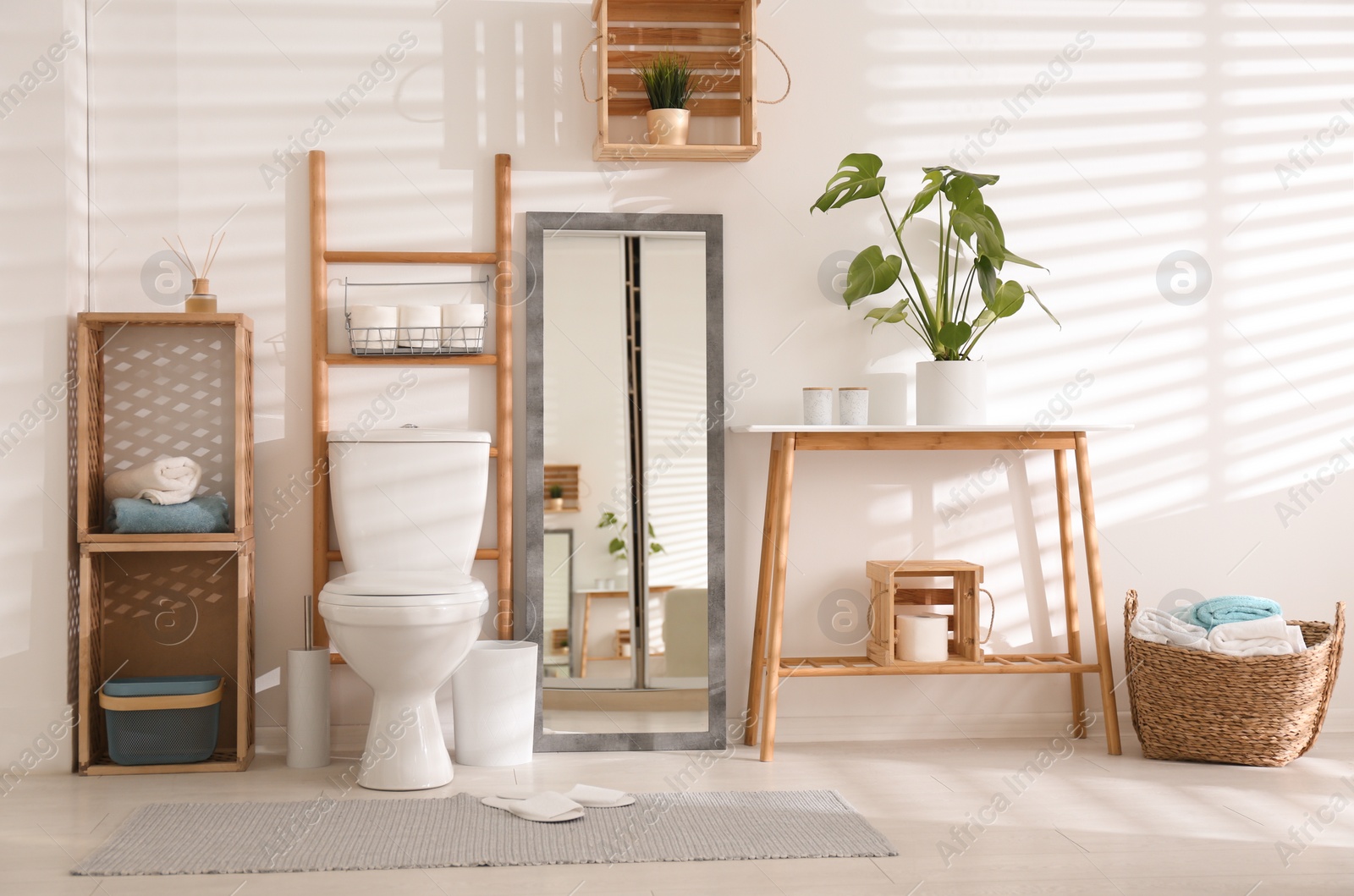 Photo of Interior of stylish bathroom with toilet bowl and decor elements