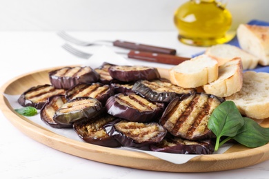 Delicious grilled eggplant slices served on white table, closeup