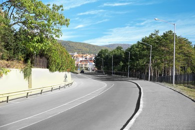 View of empty asphalt road on city street