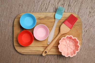 Photo of Set of cooking utensils on wooden table, top view