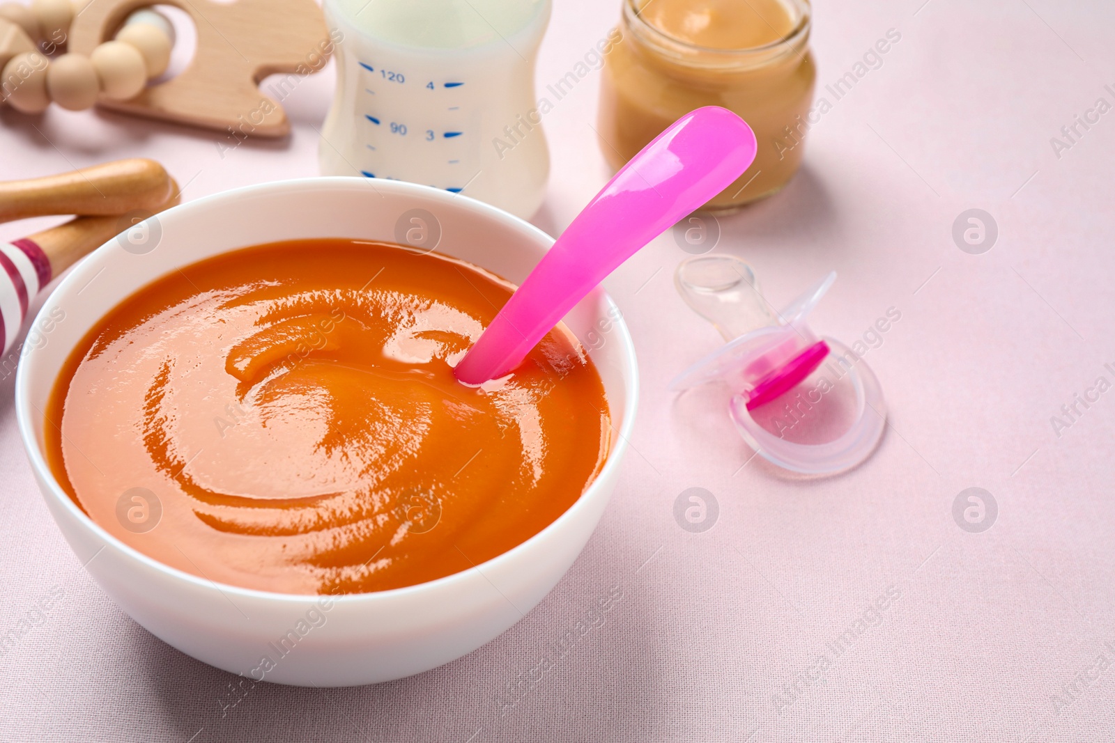 Photo of Healthy baby food in bowl on light table