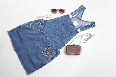 Flat lay composition with jean overall dress and accessories on white background