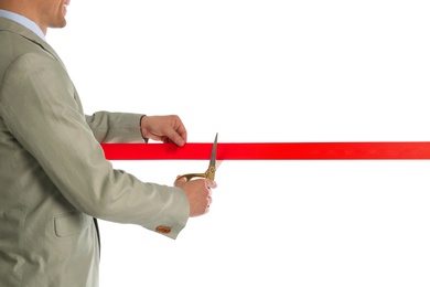 Man in office suit cutting red ribbon isolated on white, closeup