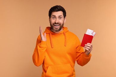Emotional man with passport and tickets on beige background