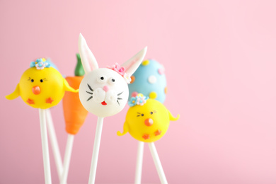 Photo of Delicious sweet cake pops on light pink background. Easter holiday