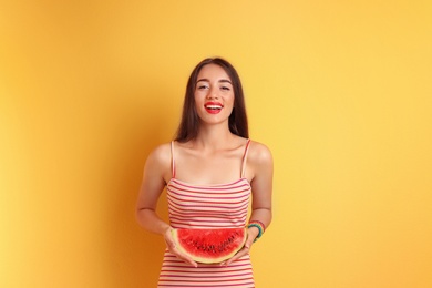 Photo of Beautiful young woman posing with watermelon on color background