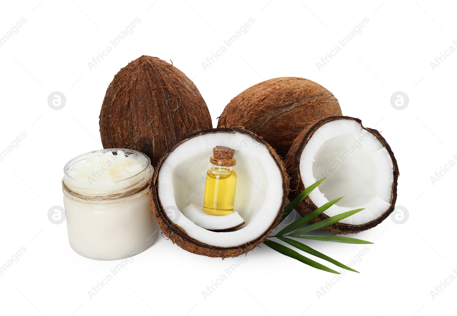 Photo of Organic coconut cooking oil, fresh fruits and green leaf isolated on white