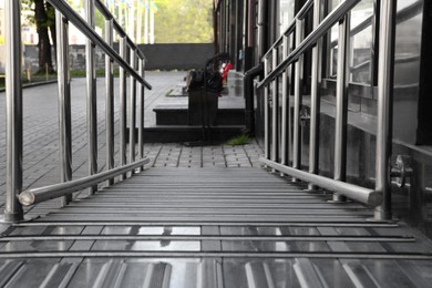 Photo of Ramp with metal railings near building outdoors