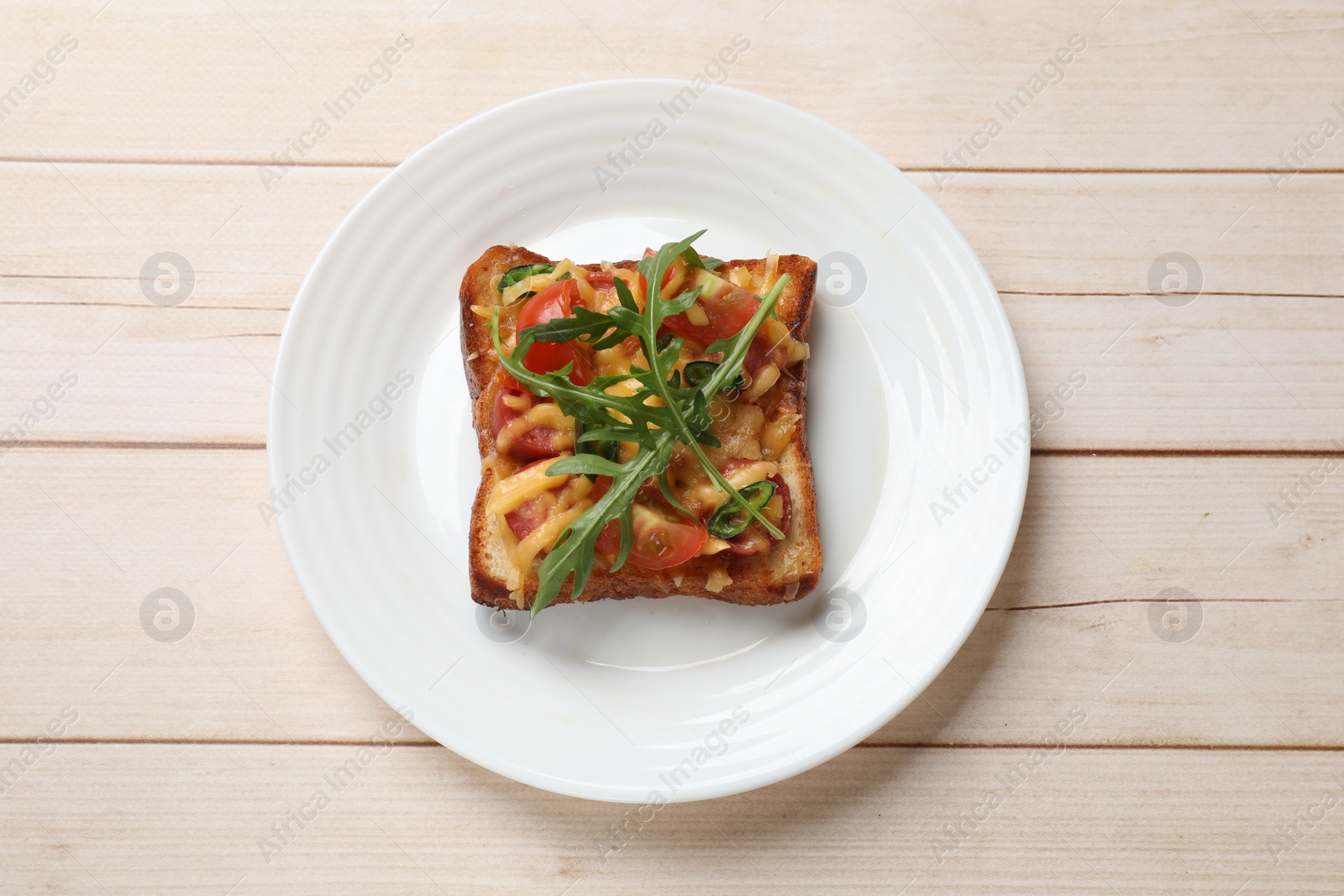 Photo of Tasty pizza toast on light wooden table, top view