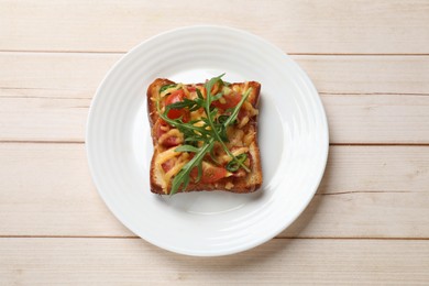 Tasty pizza toast on light wooden table, top view