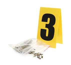 Photo of Plastic bag with cannabis and crime scene marker with number three isolated on white.