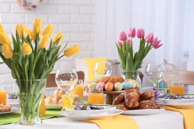 Photo of Festive Easter table setting with traditional meal at home