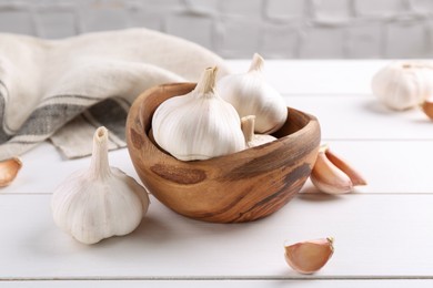 Photo of Fresh garlic on white wooden table, closeup