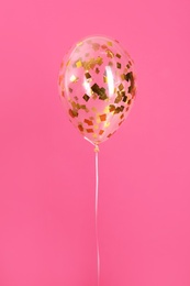 Bright balloon with sparkles on color background