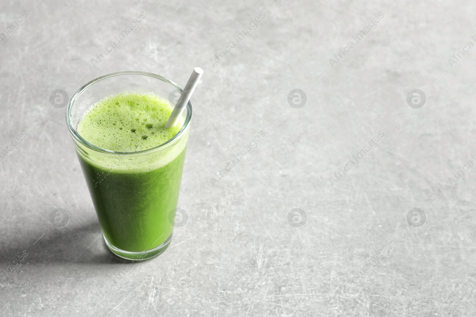 Photo of Glass with delicious detox juice on light background