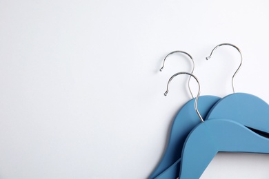 Photo of Empty clothes hangers on white background, top view