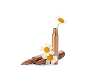 Bullets and cartridge case with beautiful flowers isolated on white