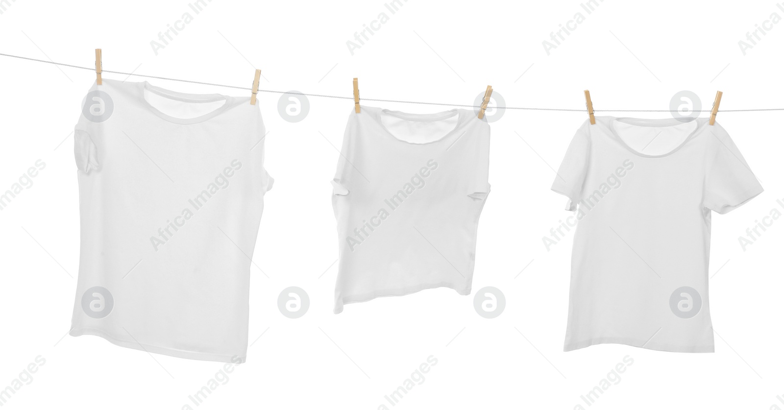 Photo of Many t-shirts drying on washing line isolated on white