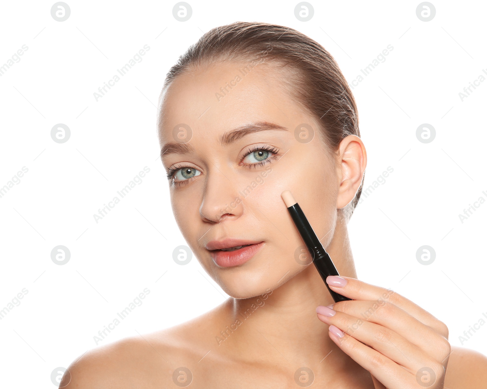 Photo of Young woman applying foundation on her face against white background