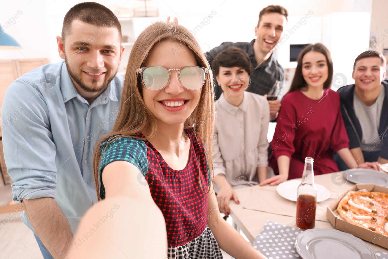 Photo of Happy friends taking selfie indoors