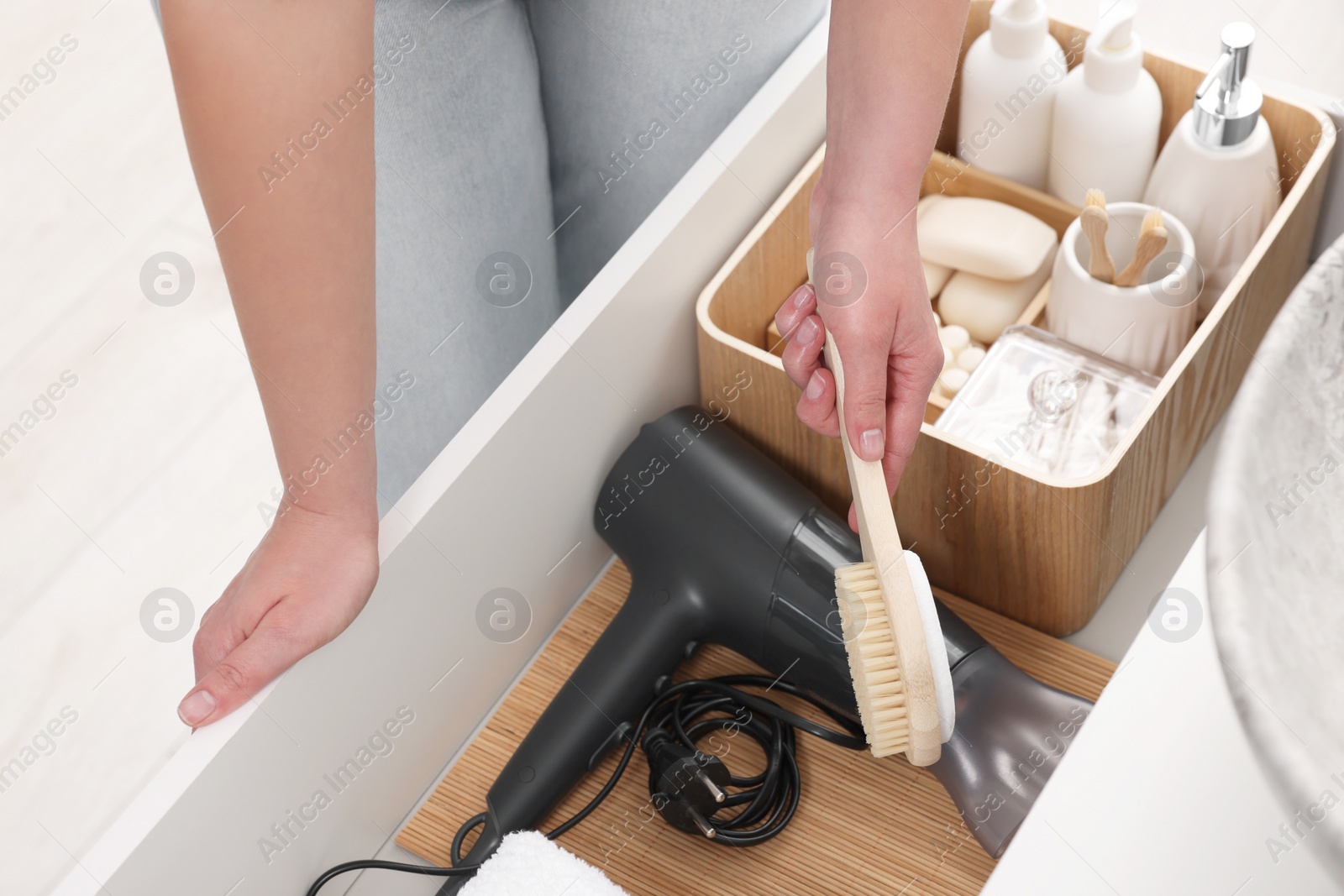 Photo of Bath accessories. Woman organizing personal care products indoors, closeup