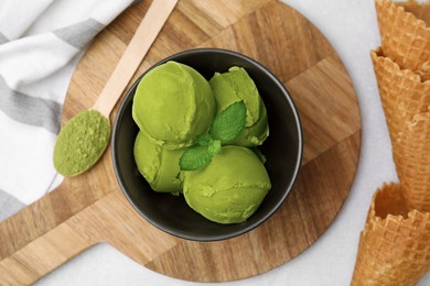 Photo of Tasty matcha ice cream in bowl on white table, flat lay