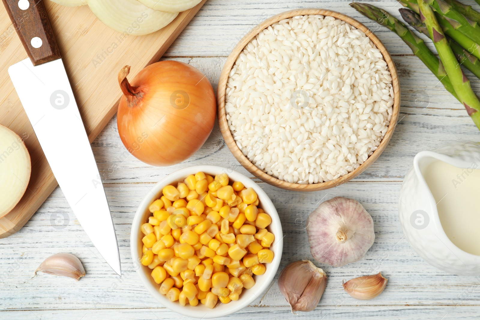 Photo of Flat lay composition with different ingredients on white wooden table. Risotto recipe