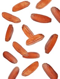 Many brown rice falling on white background. Vegan diet  