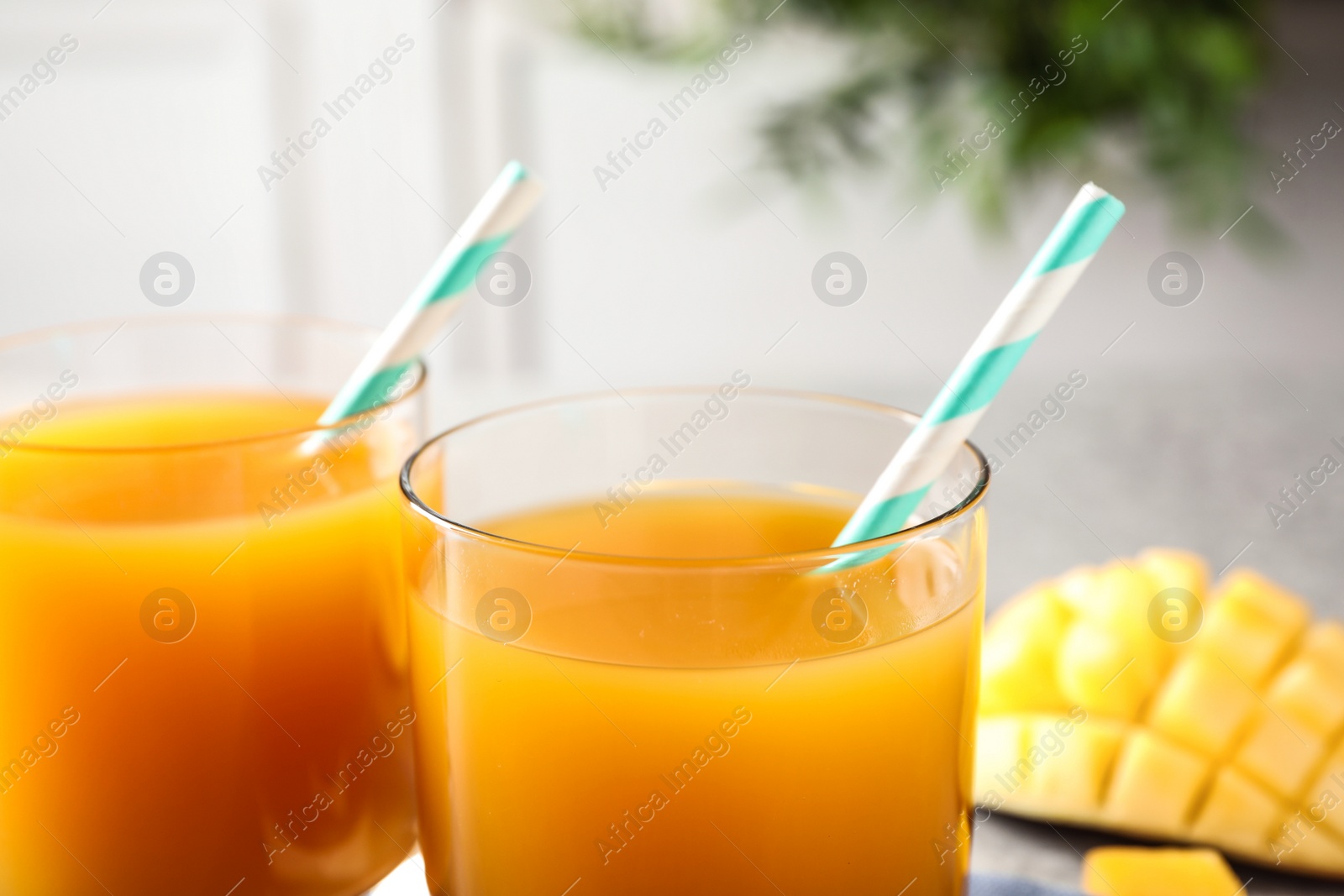 Photo of Fresh delicious mango drink on table, closeup