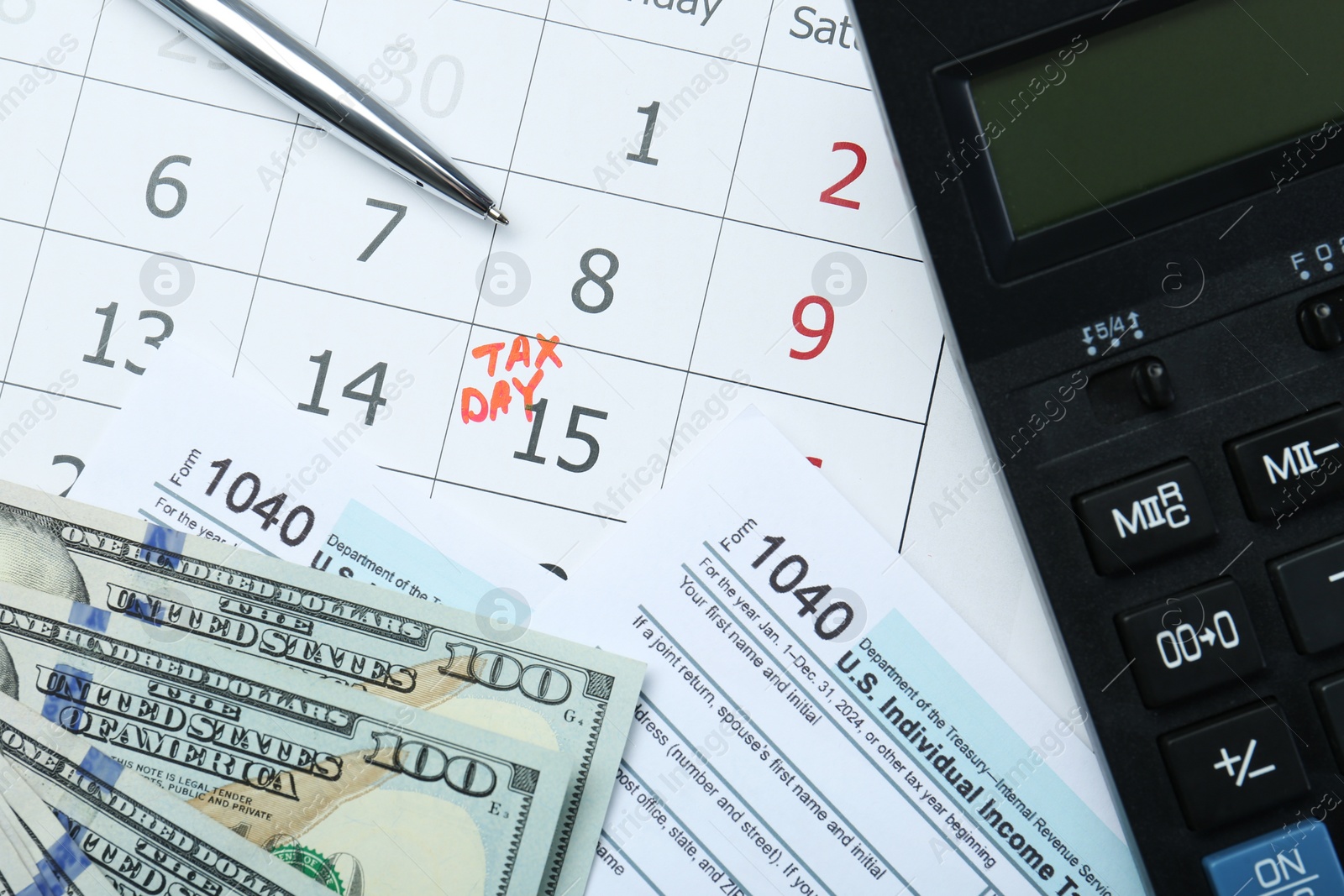 Photo of Tax day. Documents, dollar banknotes, pen and calculator on calendar with date reminder, flat lay