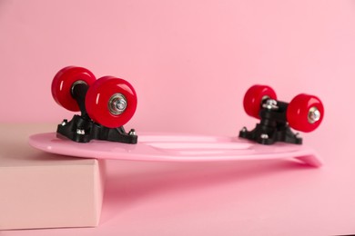 Photo of Pink skateboard on color background. Sport equipment