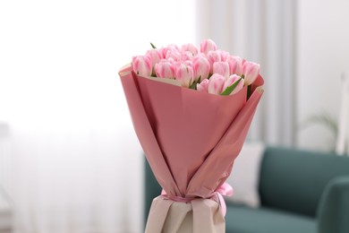 Photo of Beautiful bouquet of fresh pink tulips at home