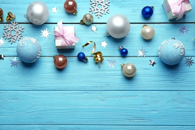 Flat lay composition with Christmas decorations on blue wooden background, space for text. Winter season