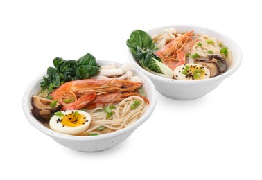 Photo of Delicious ramen with shrimps and eggs in bowls isolated on white. Noodle soup