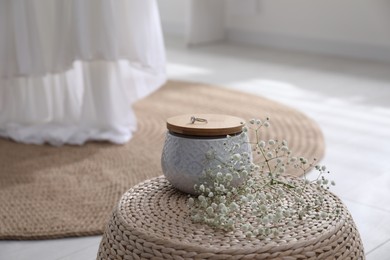 Photo of Beautiful engagement ring on jewelry jar indoors. Wedding accessory